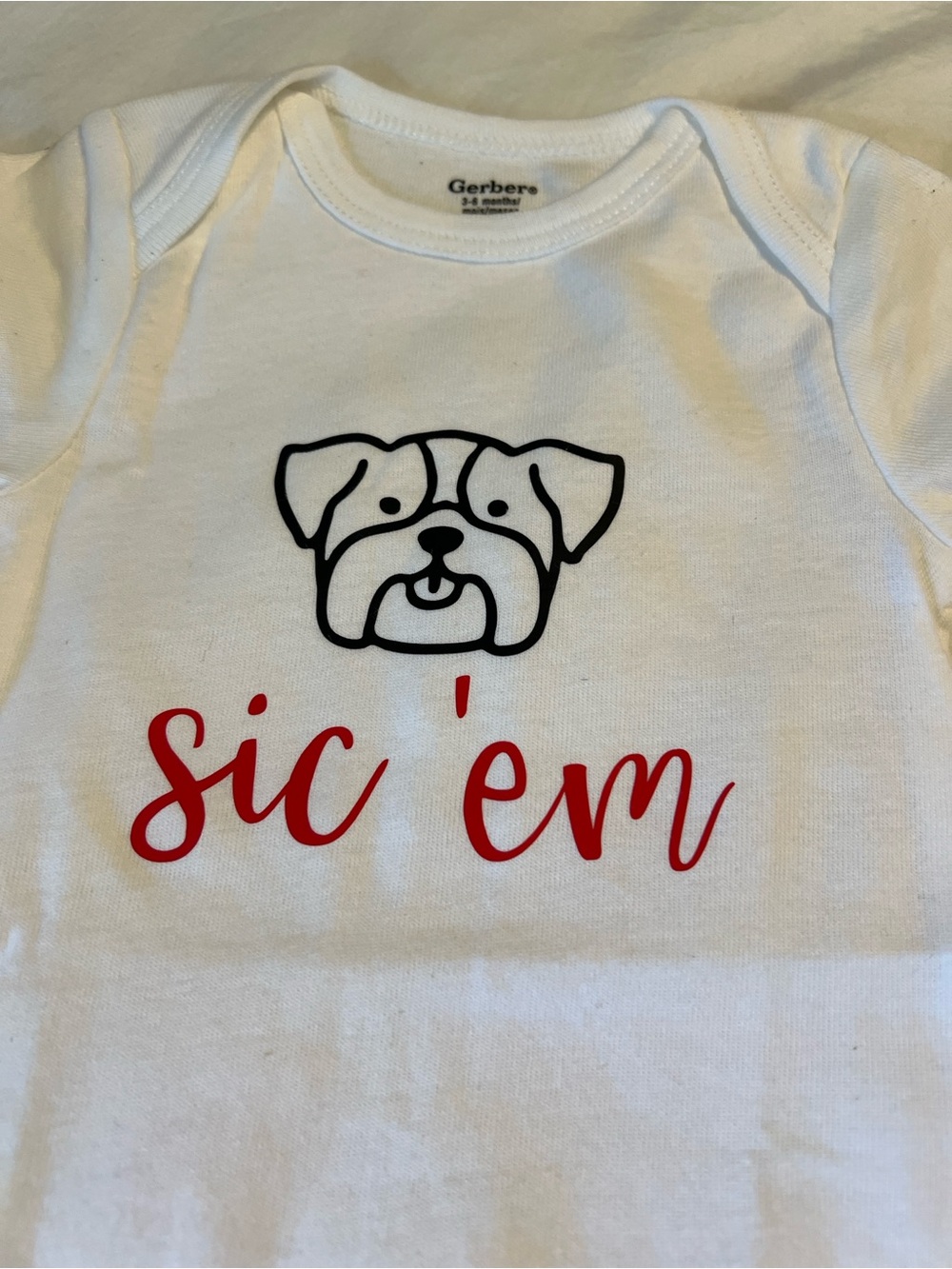 UGA- Gerber White Onesie with Black Dog Face and Red “Sic ‘em” Script